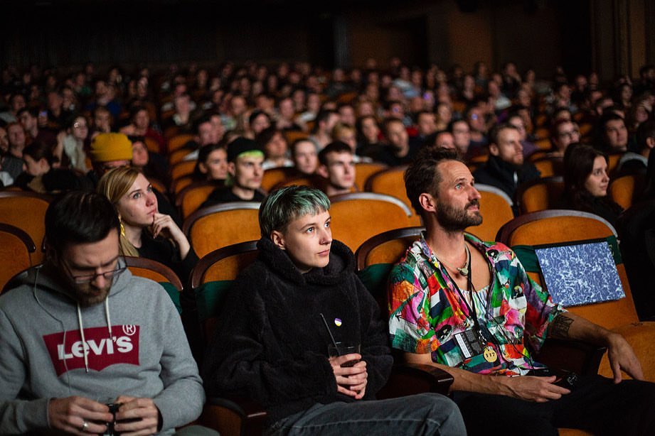 Packed cinema audience watching a screening at Mezipatra Film Festival in Prague